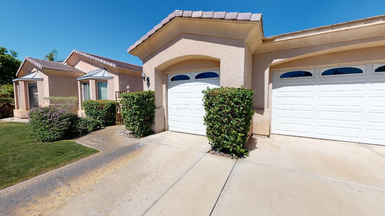 8 Picasso Court Rancho Mirage, CA 92270 - Photo 2 of 26 a front view of a house with garden