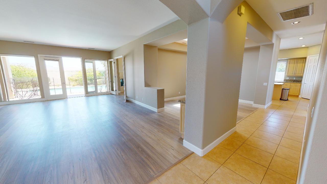 8 Picasso Court Rancho Mirage, CA 92270 - Photo 3 of 26 a view of a big room with wooden floor and windows