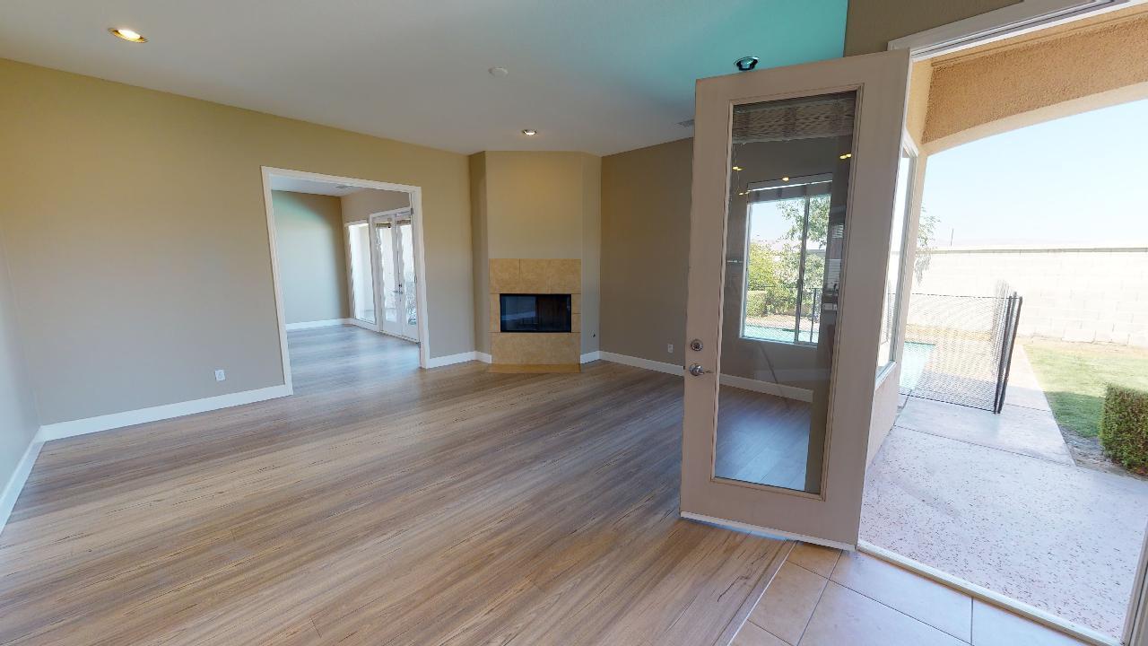 8 Picasso Court Rancho Mirage, CA 92270 - Photo 22 of 26 a view of a hallway with wooden floor and a living room