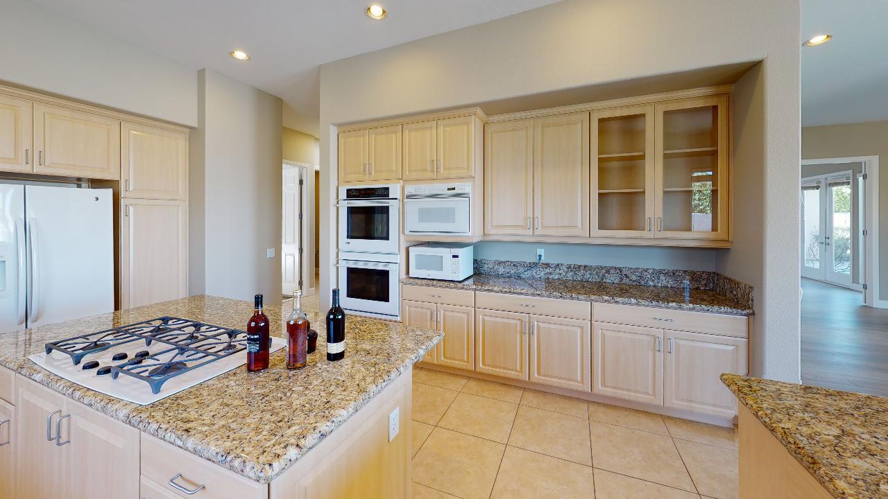 8 Picasso Court Rancho Mirage, CA 92270 - Photo 24 of 26 a kitchen with stainless steel appliances granite countertop a stove top oven a sink and cabinets