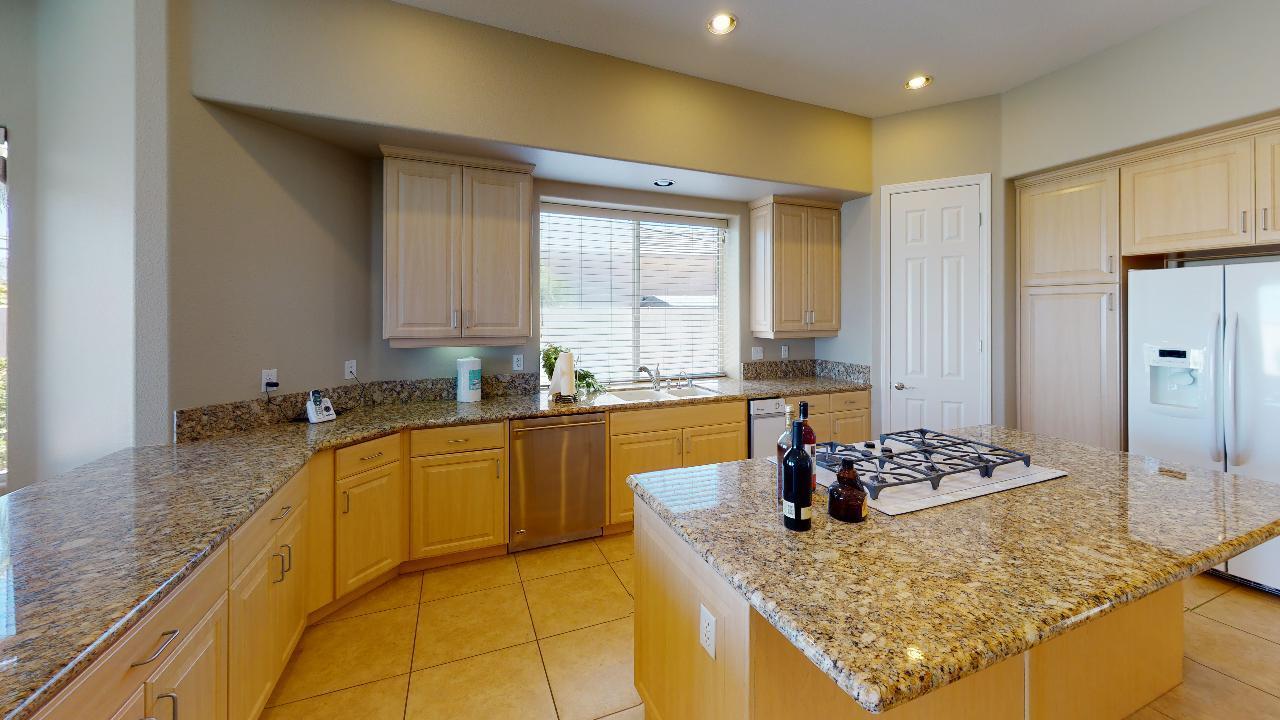 8 Picasso Court Rancho Mirage, CA 92270 - Photo 25 of 26 a kitchen with stainless steel appliances granite countertop a sink and cabinets