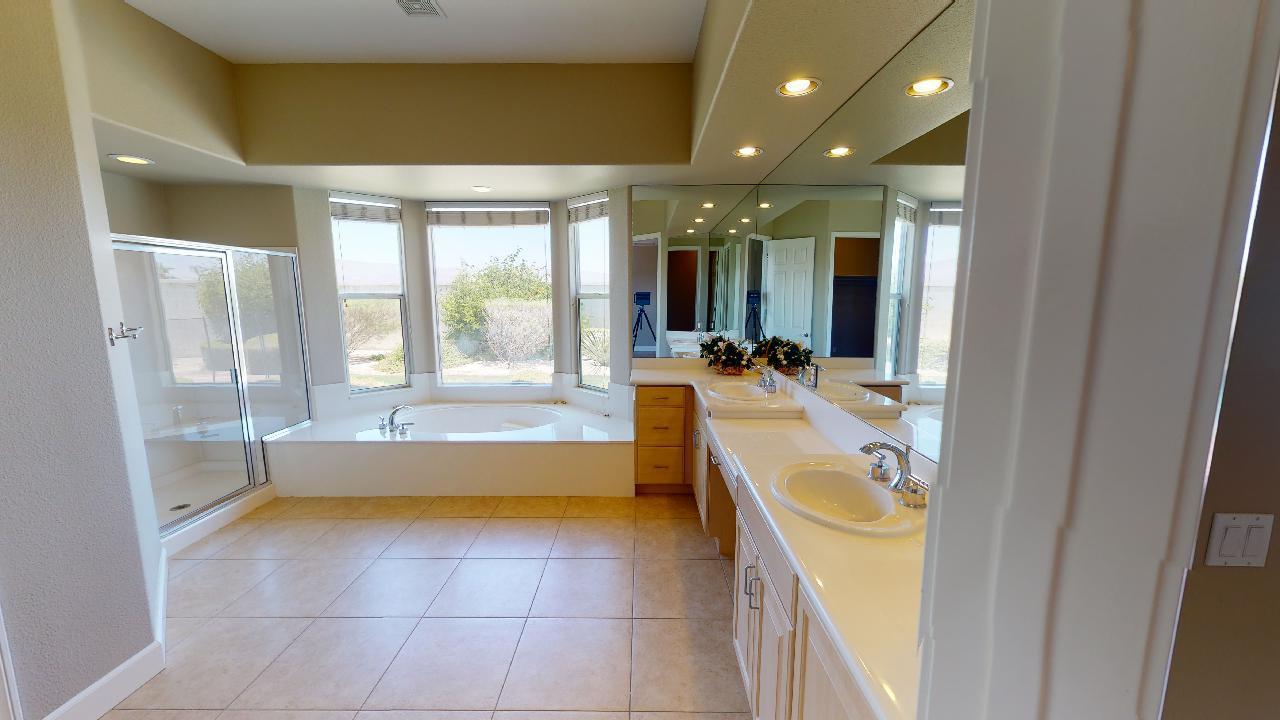 8 Picasso Court Rancho Mirage, CA 92270 - Photo 5 of 26 a bathroom with a tub sink and glass door