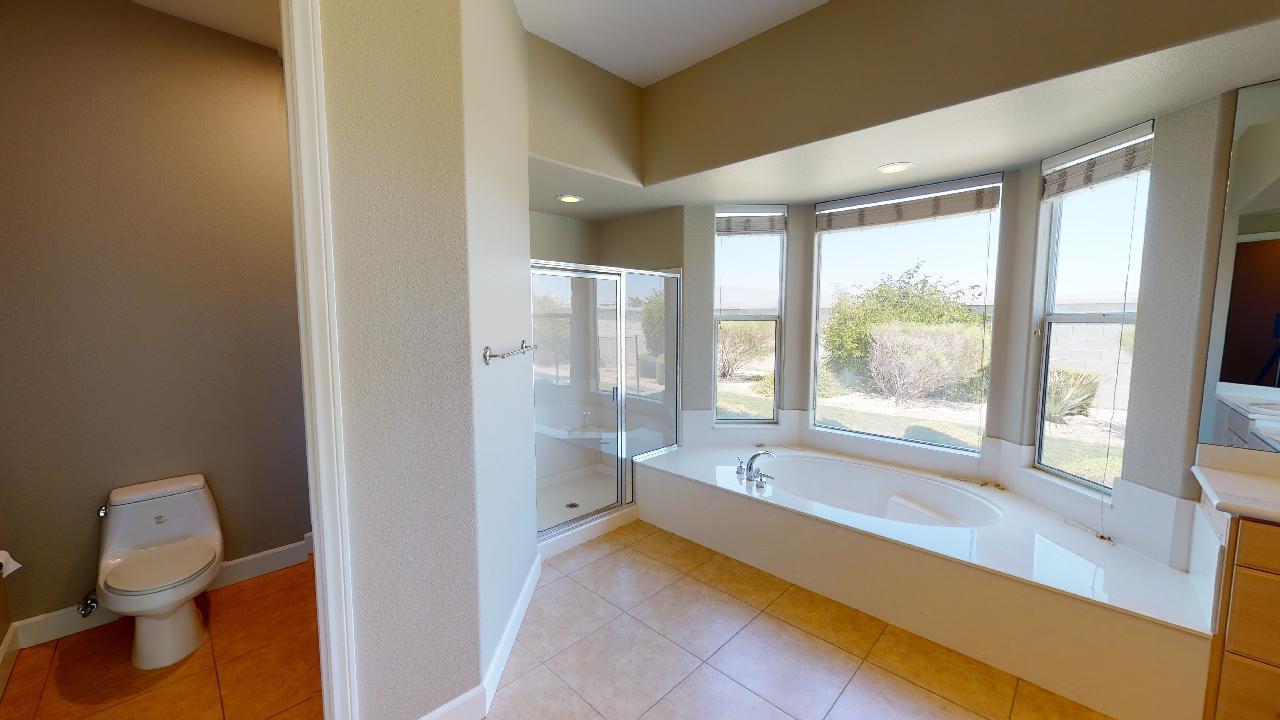 8 Picasso Court Rancho Mirage, CA 92270 - Photo 6 of 26 a spacious bathroom with a bathtub and next to a window