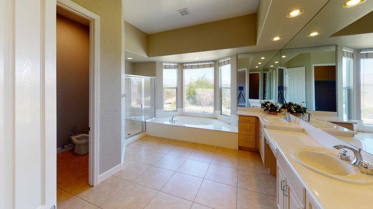 8 Picasso Court Rancho Mirage, CA 92270 - Photo 7 of 26 a bathroom with a tub sink and mirror