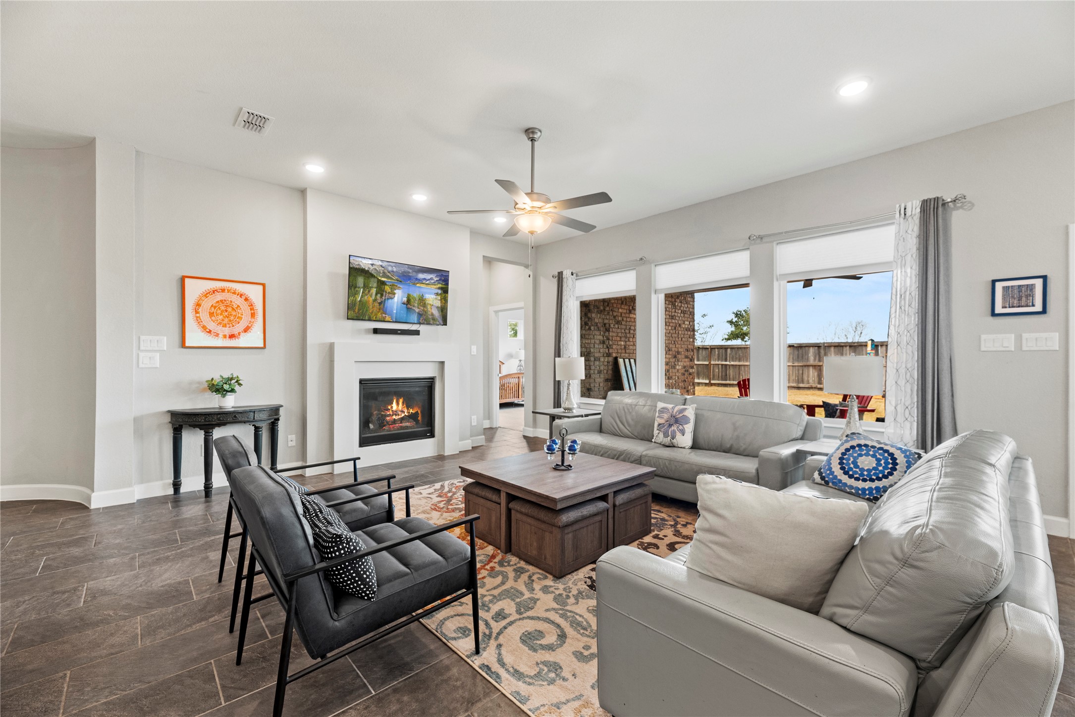 3127 Swift Way Katy, TX 77493 - Photo 9 of 25 Spacious family room with tile flooring, ceiling fan, modern fireplace and backyard views.
