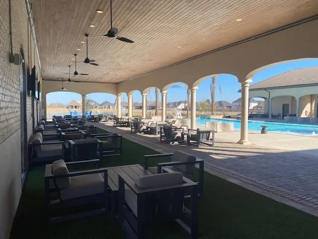 a view of a patio with couches table and chairs and potted plants