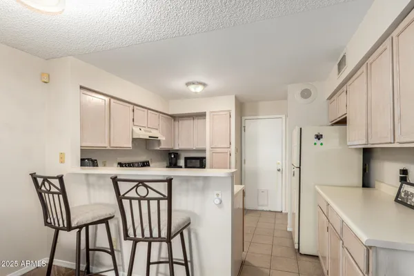 a kitchen with stainless steel appliances a white cabinets wooden floor and a sink