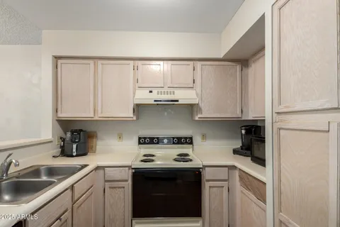 a kitchen with stainless steel appliances granite countertop white cabinets a sink and dishwasher