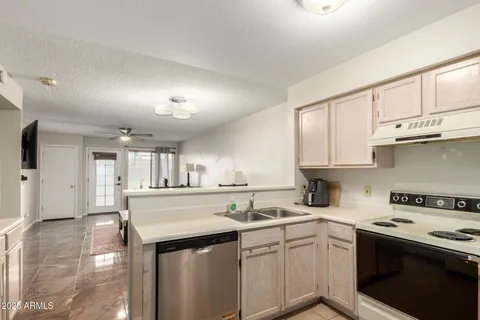 a kitchen with a sink stove and cabinets