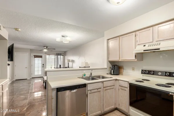 a kitchen with a sink stove and cabinets