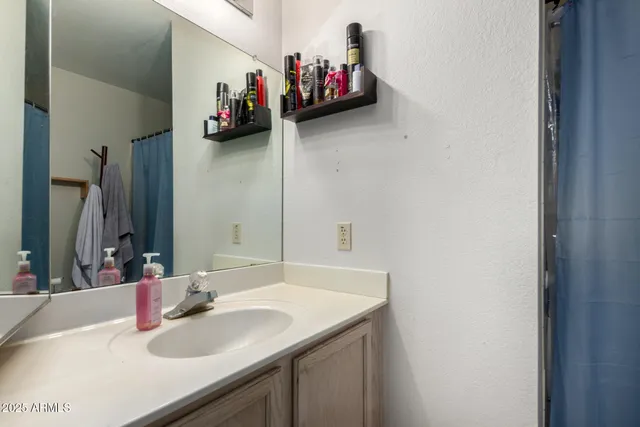a bathroom with a sink and a mirror