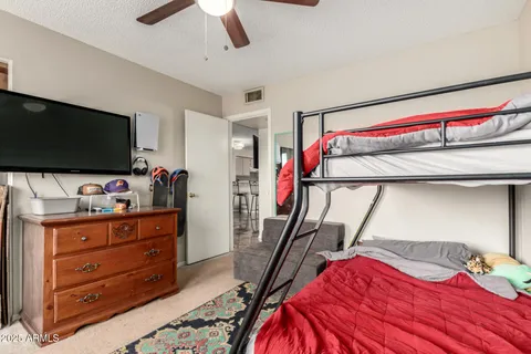 a bedroom with a bed and a flat screen tv