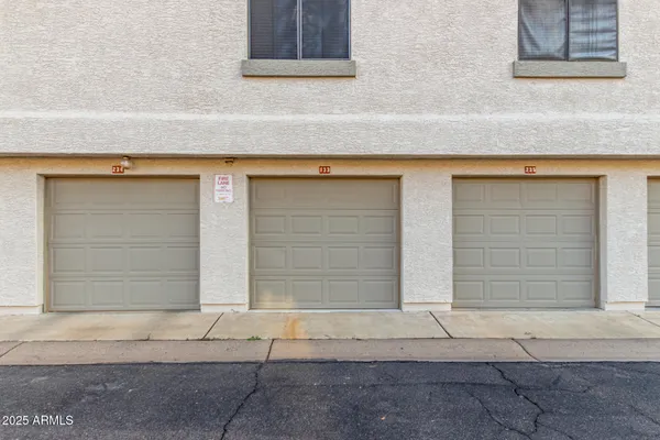a view of a swimming pool with a chair and tables in the patio
