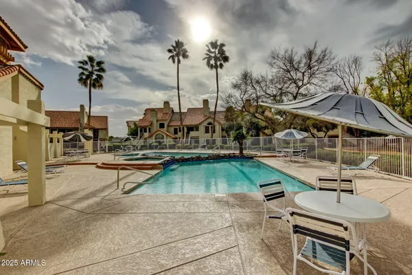 swimming pool view with a outdoor seating