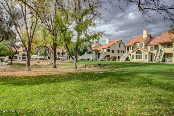 a view of a house with garden and trees