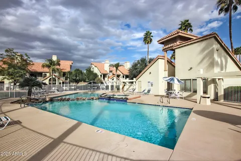 a street sign on a wall next to a road
