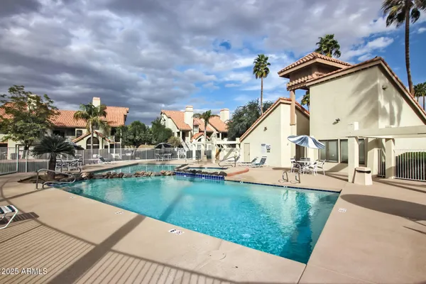 a street sign on a wall next to a road