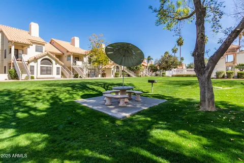 a view of a backyard with sitting area