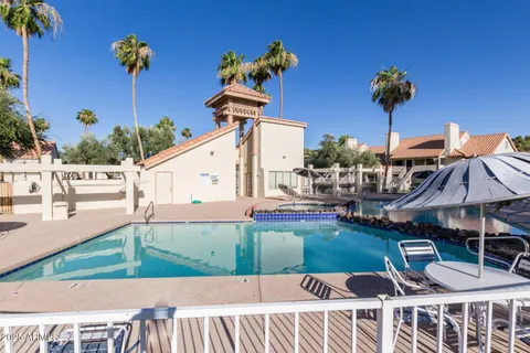 a view of a swimming pool with a house in the background