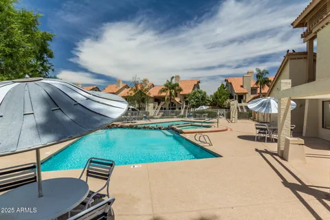 a front view of a house with a garden and tree