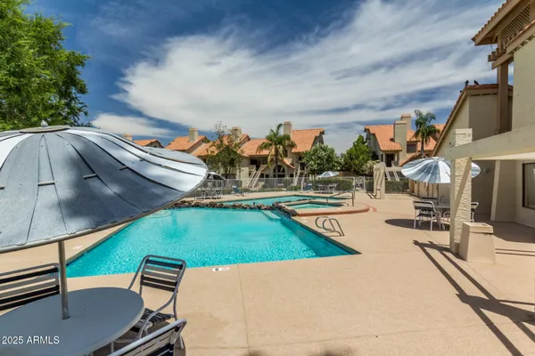 a front view of a house with a garden and tree