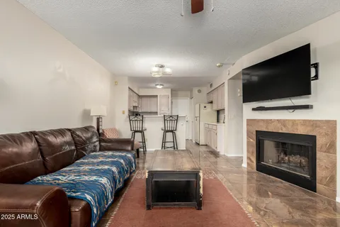 a living room with furniture fireplace and flat screen tv