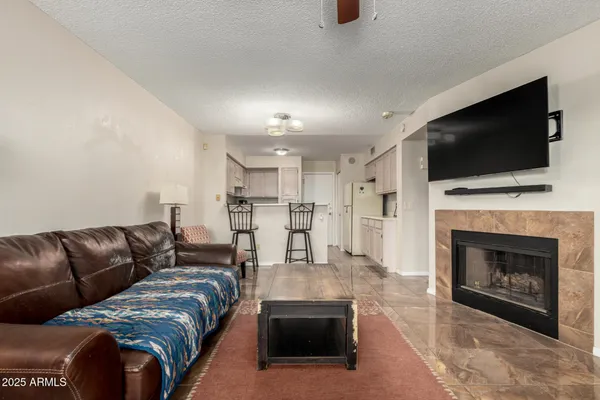 a living room with furniture fireplace and flat screen tv