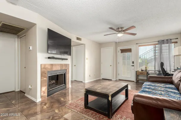 a living room with furniture a fireplace and a flat screen tv
