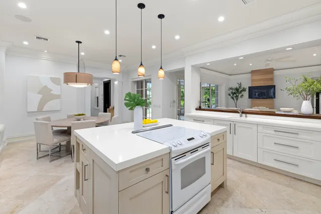 a kitchen that has a lot of cabinets in it and appliances