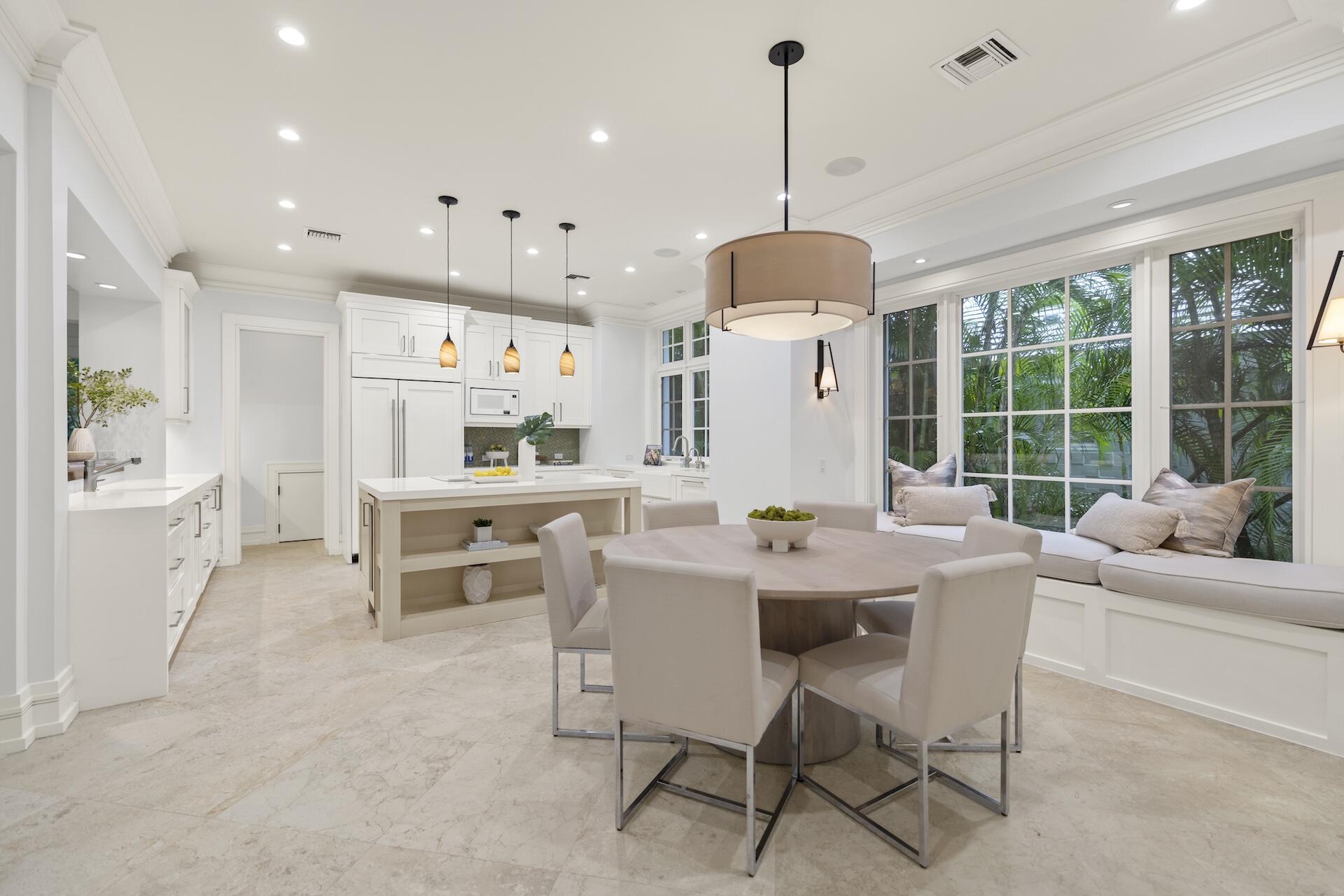 8 Osprey Drive Ocean Ridge, FL 33435 - Photo 13 of 51 a dining room with furniture a chandelier and a large window