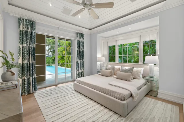 a bedroom with a large bed and a large window