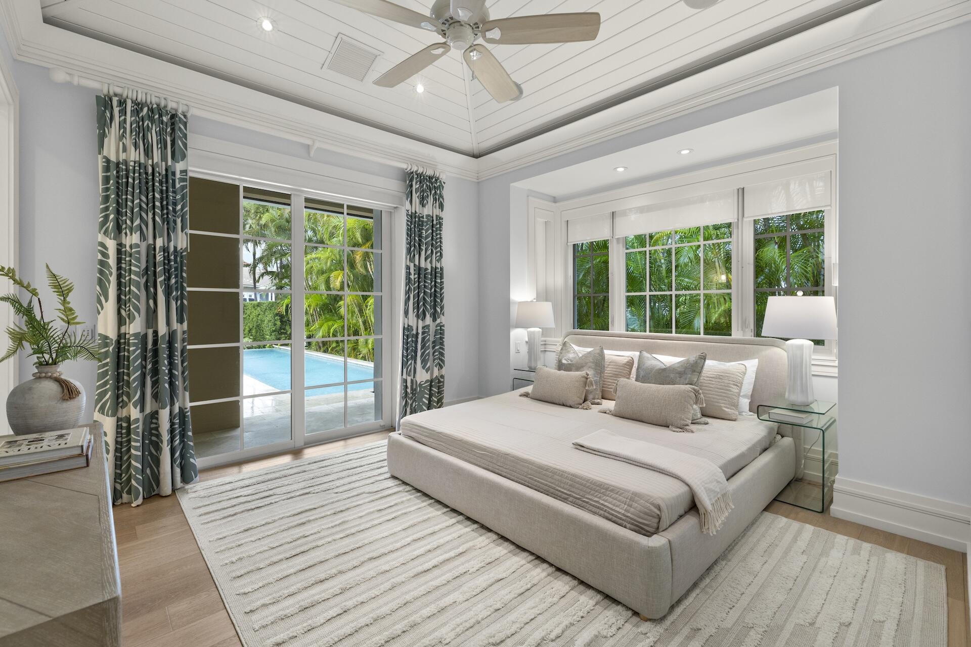 8 Osprey Drive Ocean Ridge, FL 33435 - Photo 15 of 51 a bedroom with a large bed and a large window