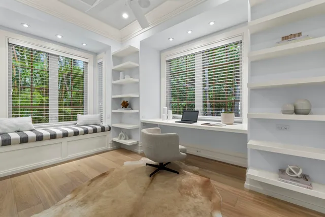 a living room with furniture and large windows