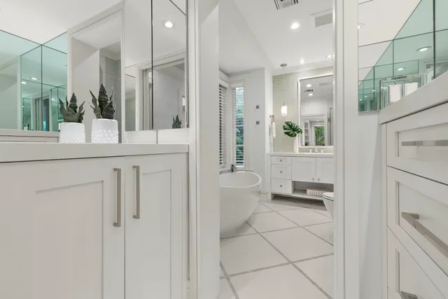 a bathroom with a granite countertop sink mirror and toilet