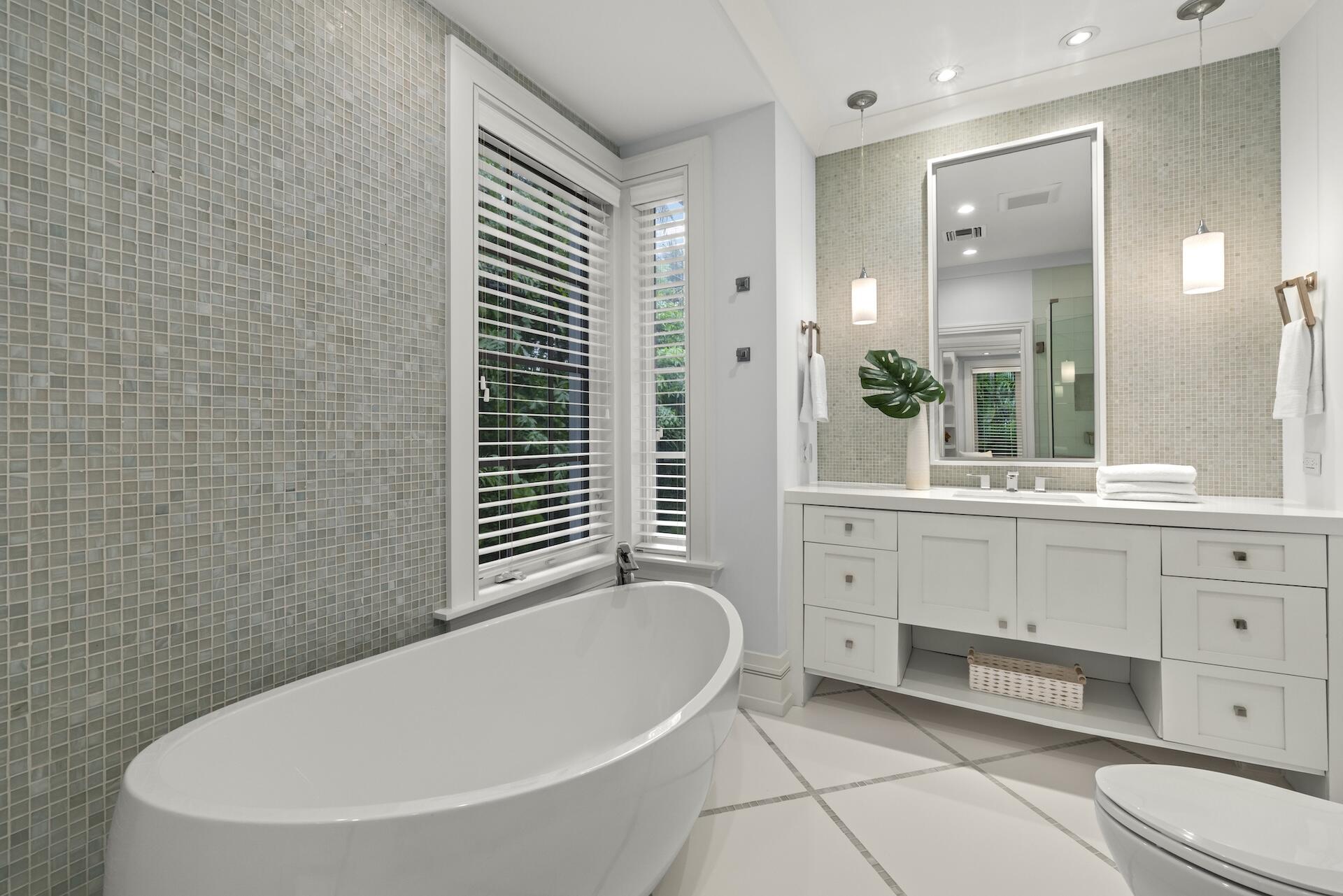 8 Osprey Drive Ocean Ridge, FL 33435 - Photo 21 of 51 a bathroom with a bathtub sink and mirror