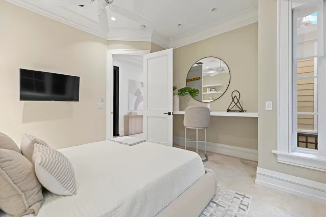 a bedroom with a large bed and a flat screen tv