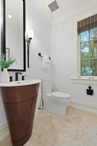 a bathroom with a sink a toilet and a mirror