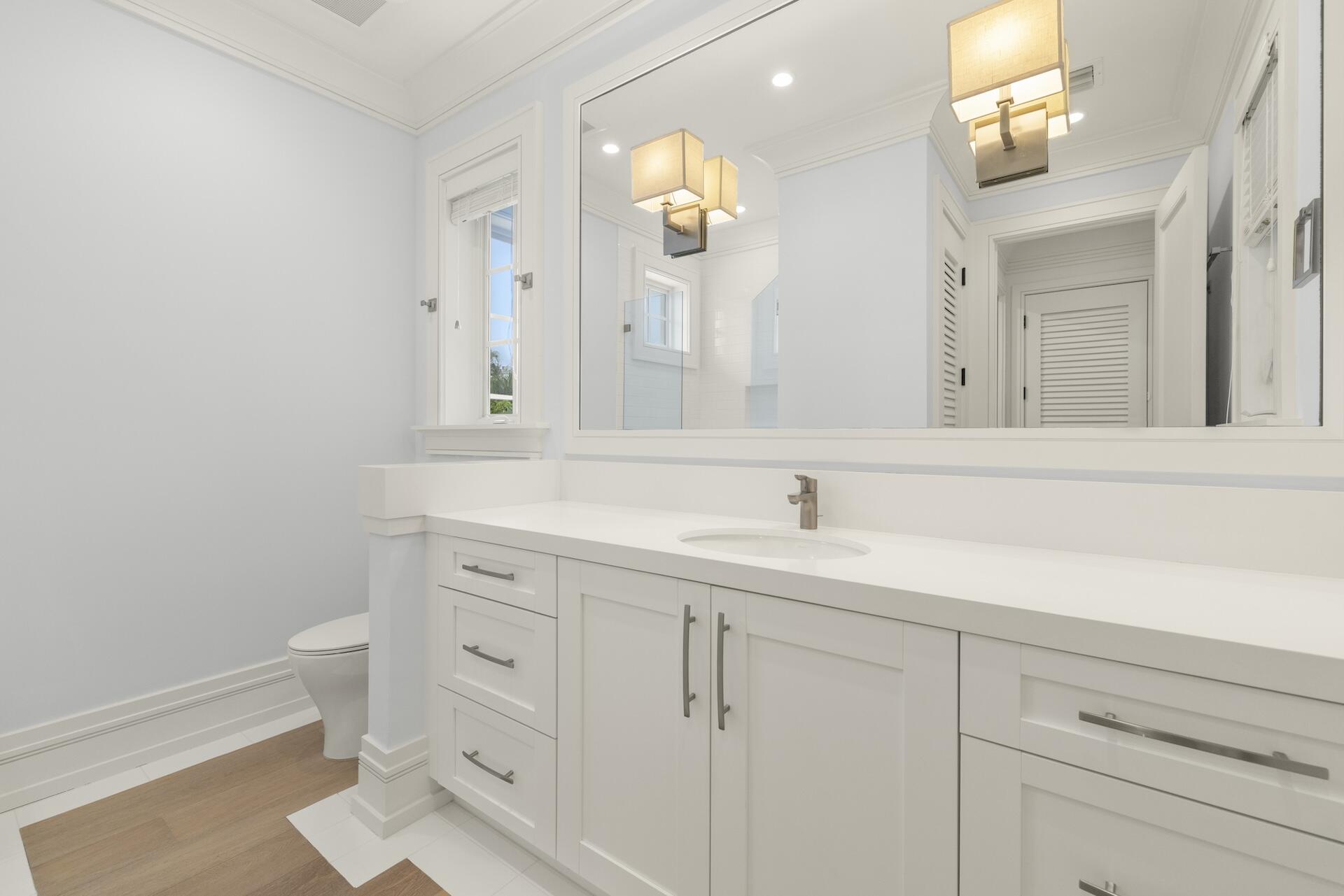 8 Osprey Drive Ocean Ridge, FL 33435 - Photo 30 of 51 a bathroom with a toilet sink and mirror