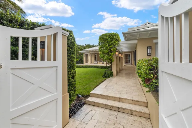 a view of a house with potted plants and a table