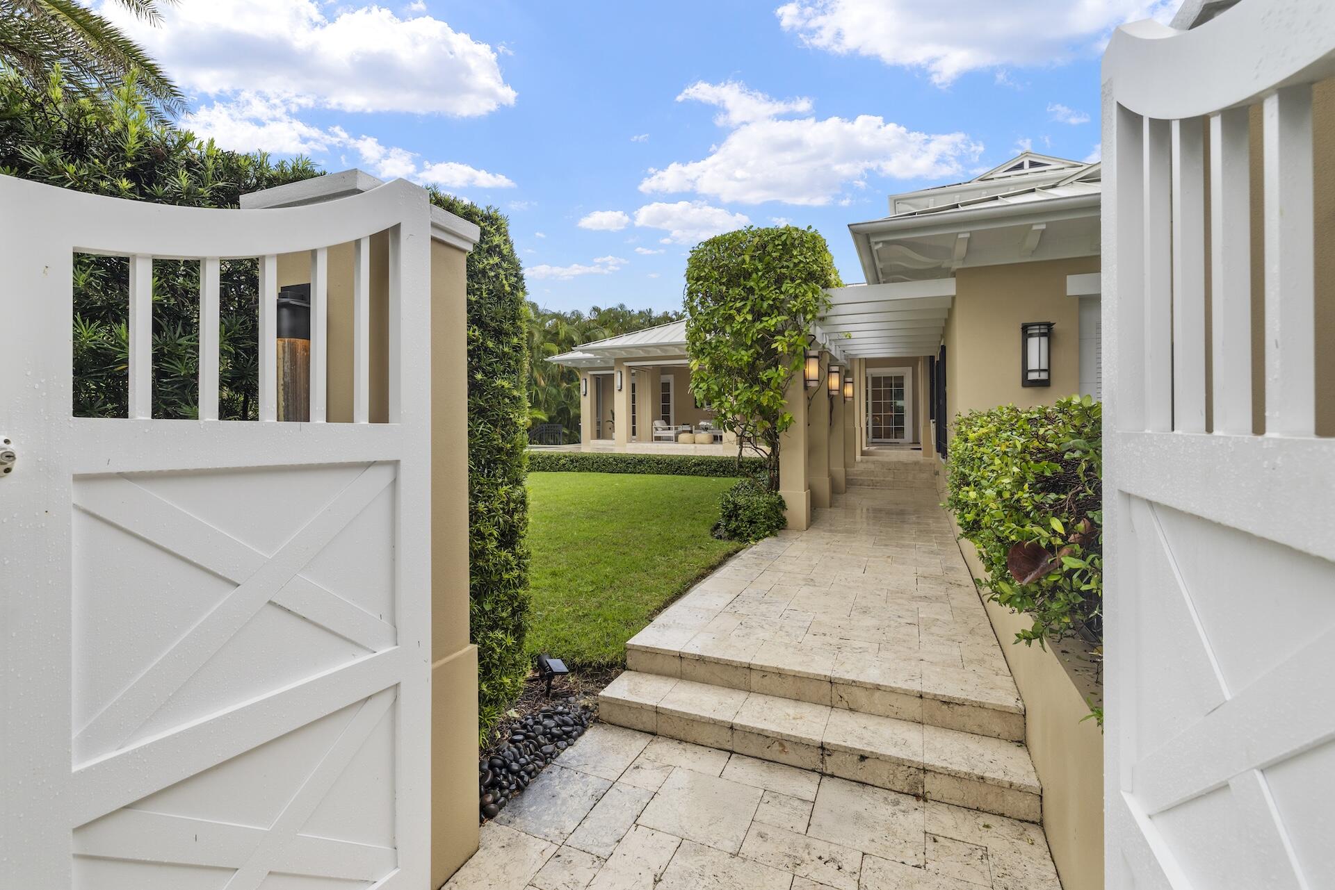 8 Osprey Drive Ocean Ridge, FL 33435 - Photo 3 of 51 a view of a house with potted plants and a table