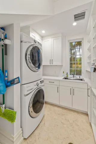 a utility room with sink dryer and washer