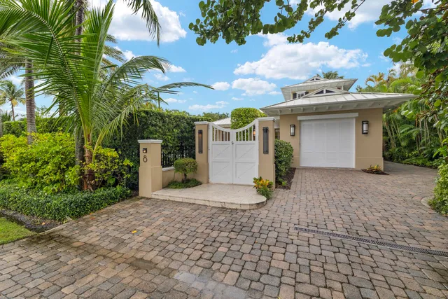 a view of a white house with a sink and yard next to a road