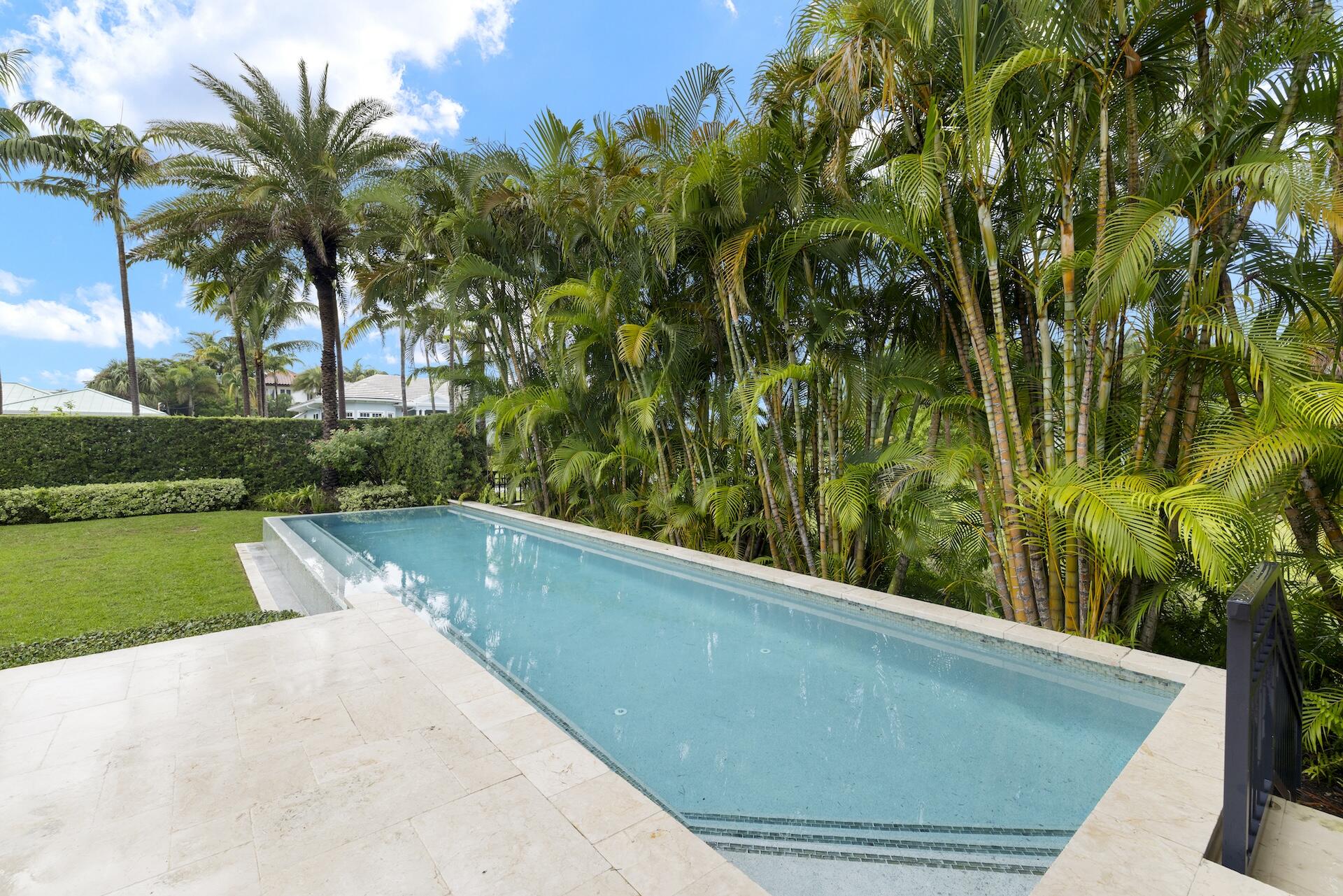 8 Osprey Drive Ocean Ridge, FL 33435 - Photo 36 of 51 a view of a swimming pool with a garden