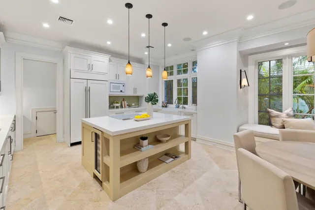 a kitchen that has a lot of cabinets in it and wooden floors