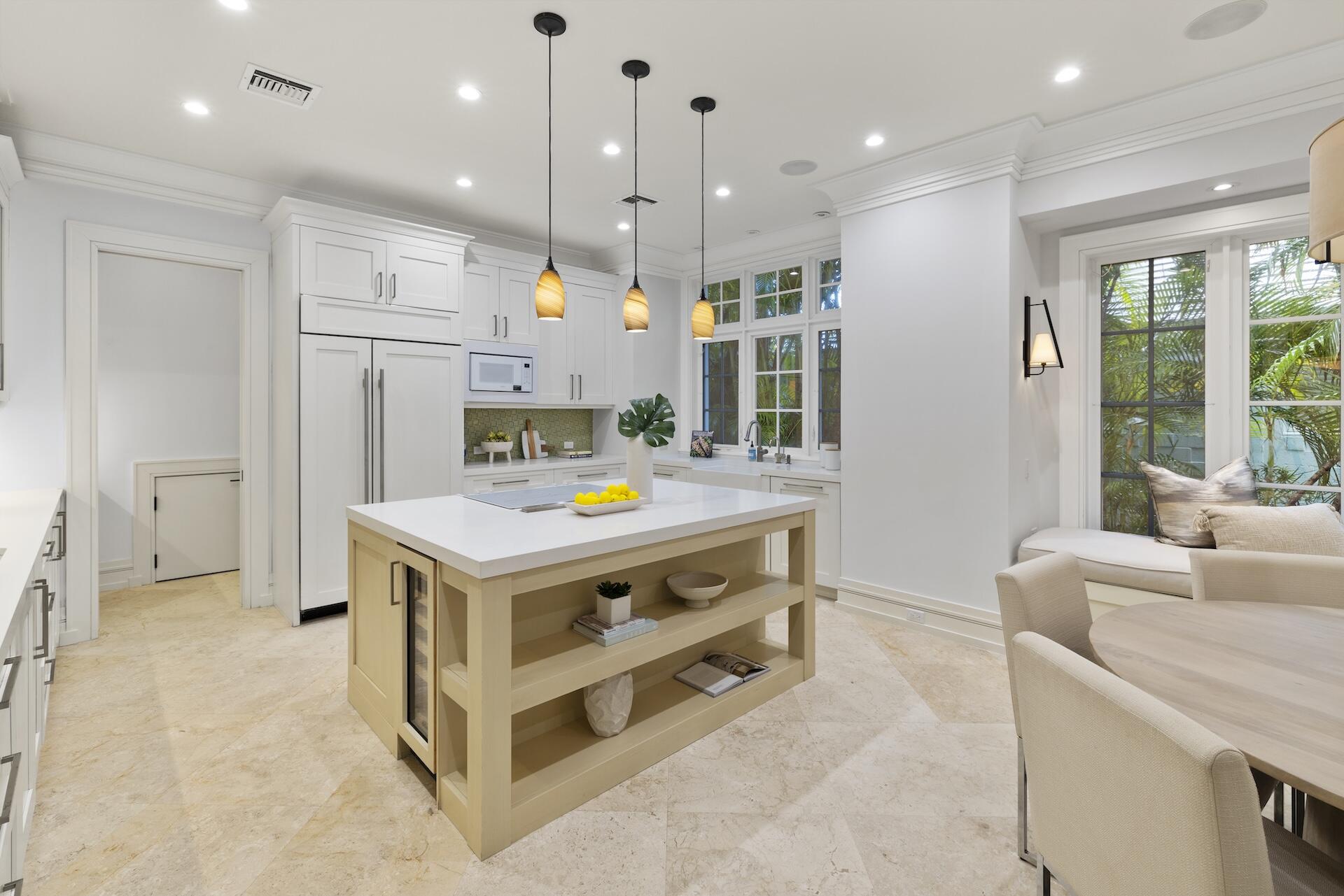 8 Osprey Drive Ocean Ridge, FL 33435 - Photo 8 of 51 a kitchen that has a lot of cabinets in it and wooden floors