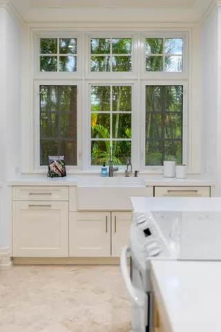 a kitchen with a sink and large window