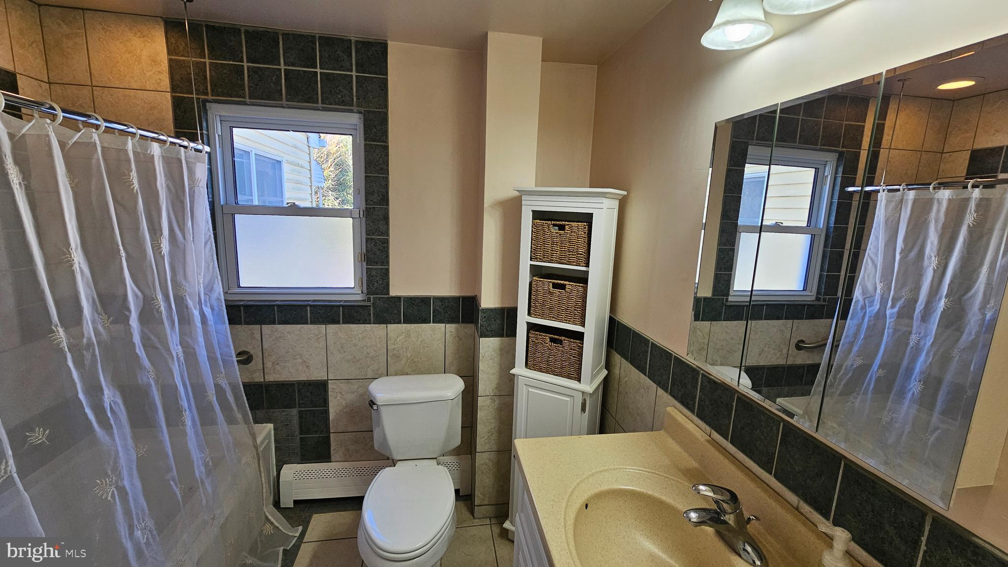 74 Ribsam Street Hamilton, NJ 08619 - Photo 20 of 35 a bathroom with a toilet a sink and a mirror