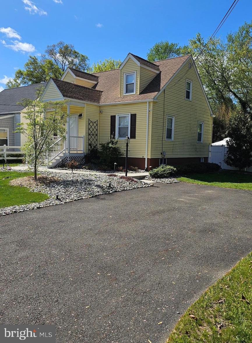 74 Ribsam Street Hamilton, NJ 08619 - Photo 5 of 35 a front view of a house with a yard and garage
