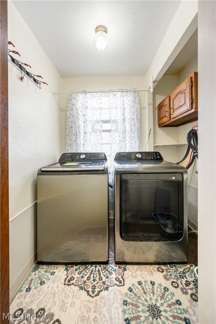 6597 York Road Parma Heights, OH 44130 - Photo 25 of 34 Clothes washing area featuring cabinets and separate washer and dryer