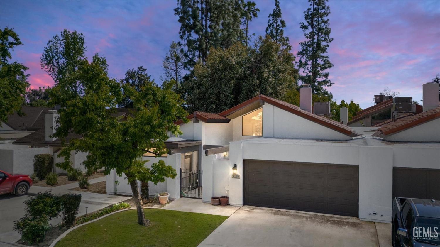 Undisclosed Address Bakersfield, CA 93309 - Photo 1 of 35 a front view of a house with a yard and garage